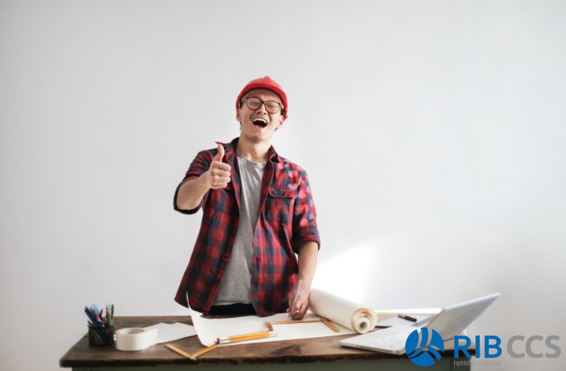 Contractor with papers and a smile and thumbs up